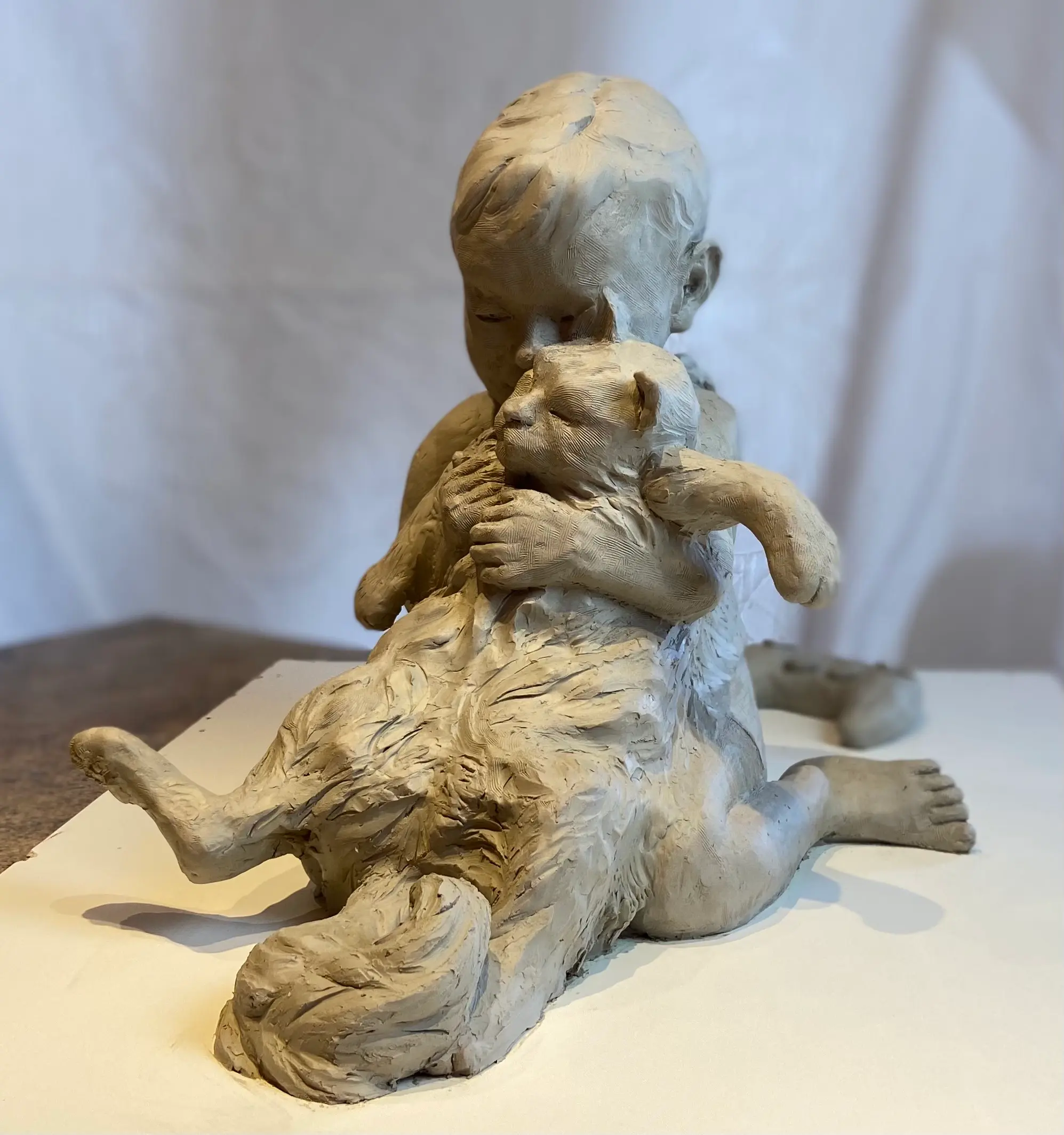 Sculpture of a child and a cat by Angela